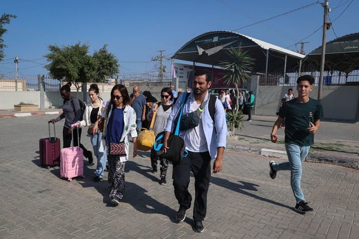 Imagem colorida mostra palestinos com passaportes estrangeiros atravessam para o Egito na Passagem de Rafah, em Gaza Itamaraty - Metrópoles