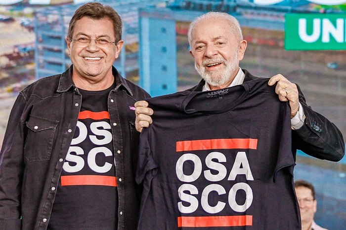 Imagem coloida mostra Emidio de Souza e Lula com camisetas com o nome de "Osasco" - Metrópoles